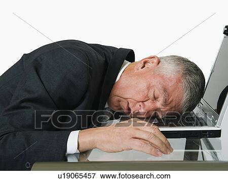 Businessman asleep at a computer View Large Photo Image Stock Photo - Businessman asleep at a computer. Fotosearch