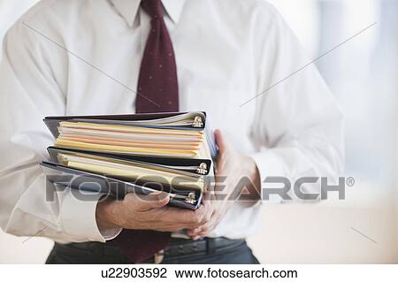 Businessman carrying binders View Large Photo Image Stock Image - Businessman carrying binders. Fotosearch