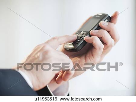 Businessman using personal digital assistant View Large Photo Image Stock Photograph - Businessman using personal digital assistant. Fotosearch