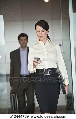 Businesswoman in office with personal digital assistant View Large Photo Image Stock Photo - Businesswoman in office with personal digital assistant. Fotosearch