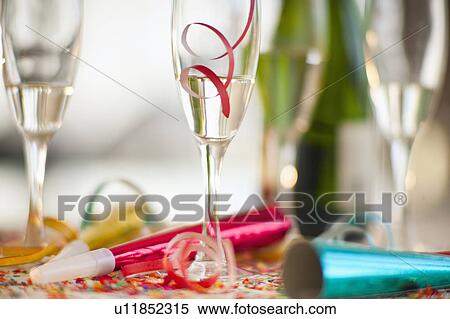 Stock Photography - Champagne bottle and party supplies. Fotosearch
