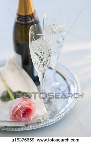 Champagne bottle and rose View Large Photo Image Stock Photo - Champagne bottle and rose. Fotosearch