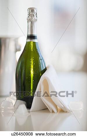 Champagne bottle with a napkin View Large Photo Image Stock Photo - Champagne bottle with a napkin. Fotosearch