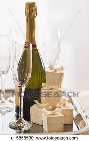 Champagne on a tray with small gift boxes View Large Photo Image Stock Image - Champagne on a tray with small gift boxes. Fotosearch