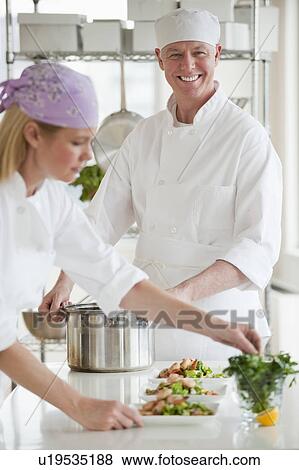 Chefs making salad in a kitchen View Large Photo Image Stock Photo - Chefs making salad in a kitchen. Fotosearch