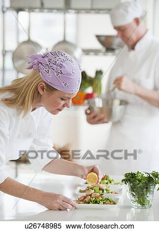Stock Photography - Chefs making salad in a kitchen. Fotosearch