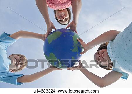 Children holding a globe View Large Photo Image Picture - Children holding a globe. Fotosearch