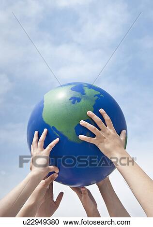 Stock Image - Children holding a globe. Fotosearch