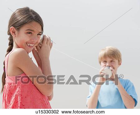 Children playing with a tin can telephone View Large Photo Image Stock Image - Children playing with a tin can telephone. Fotosearch