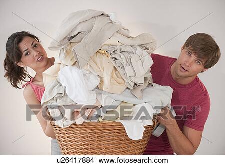 Couple doing laundry View Large Photo Image Picture - Couple doing laundry. Fotosearch