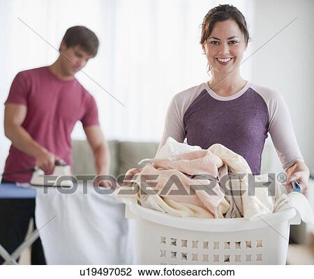 Couple doing laundry View Large Photo Image Stock Image - Couple doing laundry. Fotosearch