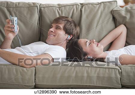 Couple in living room listening to music View Large Photo Image Stock Image - Couple in living room listening to music. Fotosearch
