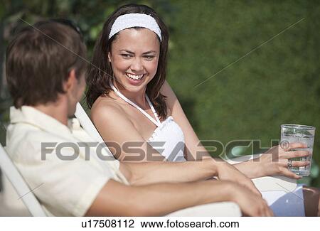 Stock Image - Couple relaxing outdoors. Fotosearch