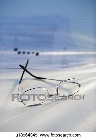 Stock Photography - Eyeglasses near some paperwork. Fotosearch