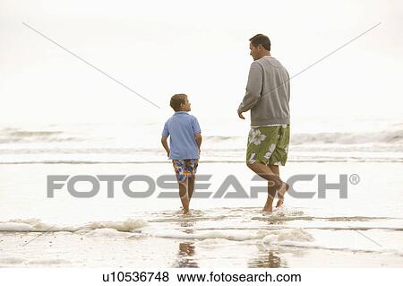 Father and son at the beach View Large Photo Image Stock Photo - Father and son at the beach. Fotosearch
