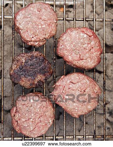 Stock Photo - Hamburgers on a barbeque. Fotosearch