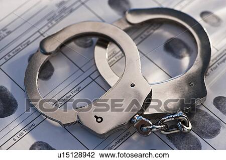 Hand cuffs on a page of fingerprints View Large Photo Image Stock Image - Hand cuffs on a page of fingerprints. Fotosearch