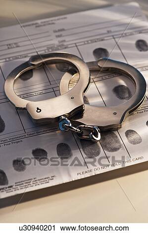 Hand cuffs on a page of fingerprints View Large Photo Image Stock Image - Hand cuffs on a page of fingerprints. Fotosearch