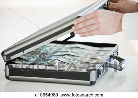Hands closing a briefcase with money in it View Large Photo Image Stock Photo - Hands closing a briefcase with money in it. Fotosearch