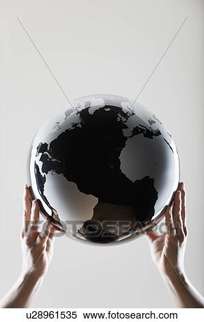 Hands holding a globe View Large Photo Image Stock Photography - Hands holding a globe. Fotosearch