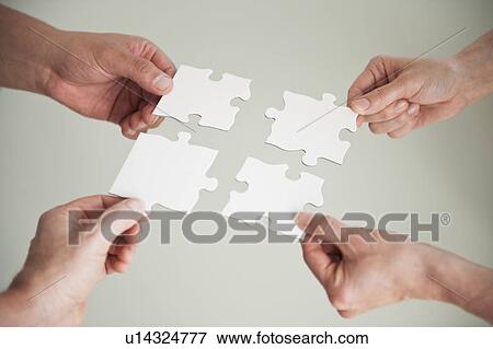 Hands holding puzzle pieces View Large Photo Image Stock Photo - Hands holding puzzle pieces. Fotosearch