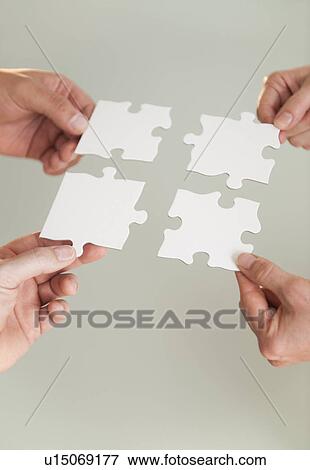 Hands holding puzzle pieces View Large Photo Image Stock Photo - Hands holding puzzle pieces. Fotosearch