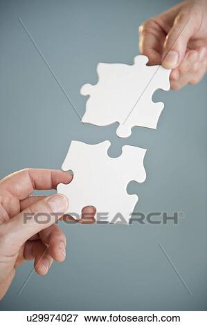 Hands holding puzzle pieces View Large Photo Image Stock Photo - Hands holding puzzle pieces. Fotosearch
