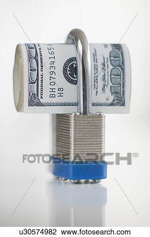 Stock Image - Hundred dollar bills in a padlock. Fotosearch