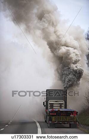 Stock Image - Large semi truck emitting exhaust fumes. Fotosearch