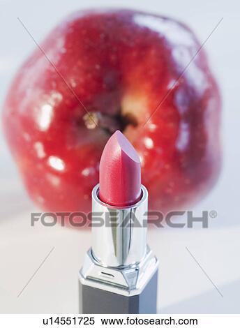 Stock Photography - Lipstick and a red apple. Fotosearch