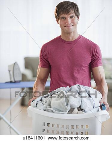 Stock Image - Man doing laundry. Fotosearch