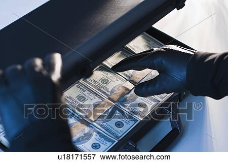 Money in a briefcase with gloved hands View Large Photo Image Stock Photo - Money in a briefcase with gloved hands. Fotosearch