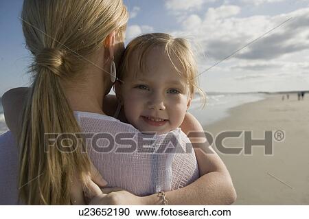 Stock Image - Mother and daughter at the beach. Fotosearch