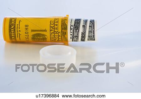Pill bottle with bank notes View Large Photo Image Picture - Pill bottle with bank notes. Fotosearch