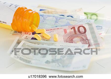Stock Photograph - Pill bottle with bank notes. Fotosearch