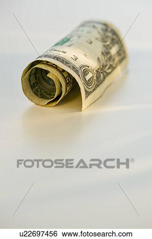Stock Photograph - Rolled up dollar bill. Fotosearch