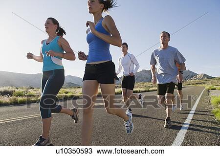 Stock Image - Runners on a road. Fotosearch