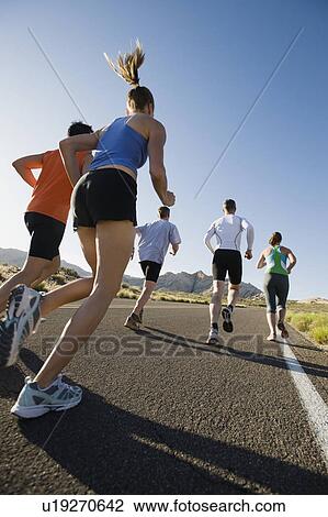 Stock Image - Runners on a road. Fotosearch