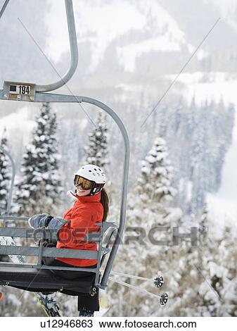 Skiers on a ski lift View Large Photo Image Stock Image - Skiers on a ski lift. Fotosearch