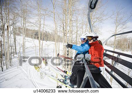 Skiers on a ski lift View Large Photo Image Stock Image - Skiers on a ski lift. Fotosearch