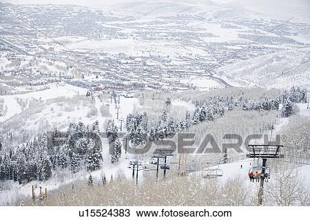 Stock Image - Skiers on a ski lift. Fotosearch