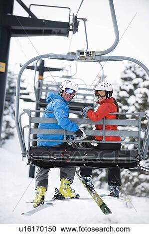 Skiers on a ski lift View Large Photo Image Stock Image - Skiers on a ski lift. Fotosearch