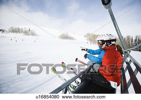 Skiers on a ski lift View Large Photo Image Stock Image - Skiers on a ski lift. Fotosearch