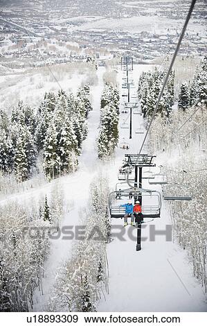 Stock Photo - Skiers on a ski lift. Fotosearch