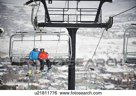 Skiers on a ski lift View Large Photo Image Stock Photograph - Skiers on a ski lift. Fotosearch