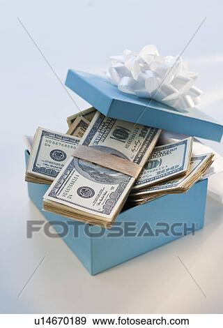 Stacks of money in a gift box View Large Photo Image Stock Photo - Stacks of money in a gift box. Fotosearch