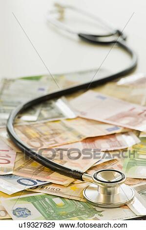 Stethoscope on bank notes View Large Photo Image Stock Photo - Stethoscope on bank notes. Fotosearch