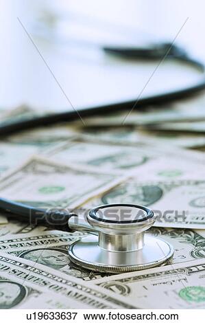 Stethoscope on bank notes View Large Photo Image Stock Photo - Stethoscope on bank notes. Fotosearch