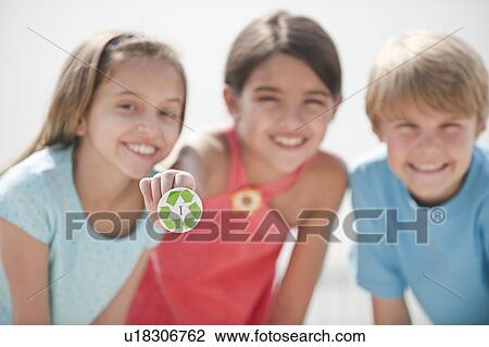 Stock Image - Three children with a recycling button. Fotosearch