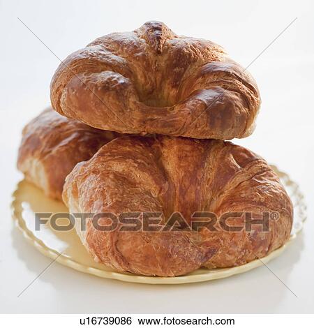 Stock Photograph - Three croissants on a plate. Fotosearch